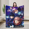 A person holds up a blanket featuring characters from Jujutsu Kaisen, including Gojo Satoru, in a dark purple and blue design