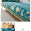 A teal jacquard sofa seat and back cover featuring a botanical pattern of yellow and green leaves on a white background.
