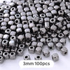 A pile of small, silver-colored geometric acrylic beads for jewelry making