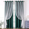 A pair of floor-length, double-layer decorative curtains in dark green and sheer white fabric hanging on a rod.