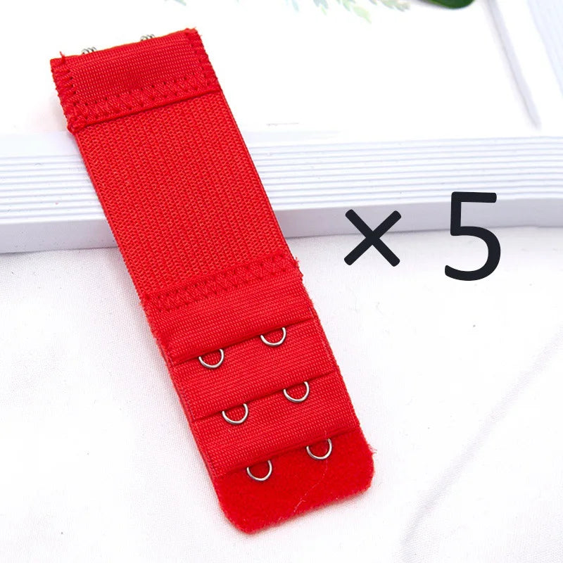 Five red adjustable bra extender straps laid out on a white surface.