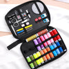 A black sewing kit bag containing various tools like scissors needles and embroidery supplies