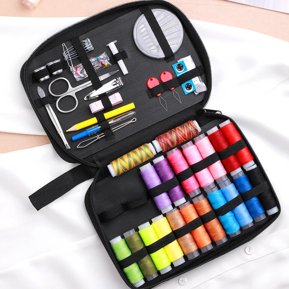 A black sewing kit bag containing various tools like scissors needles and embroidery supplies
