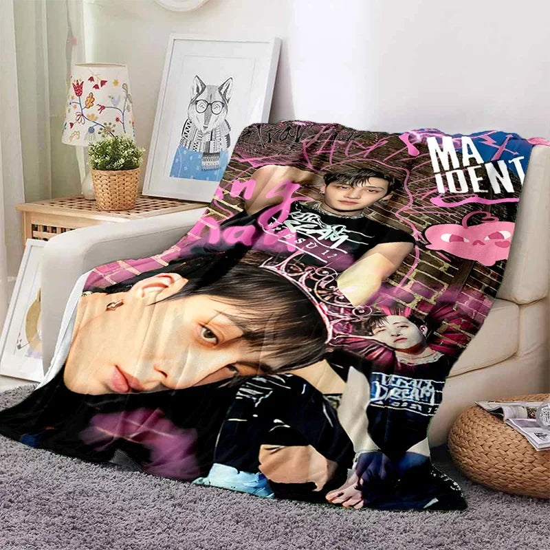 A fleece throw blanket featuring a 3D print design of Stray Kids members.