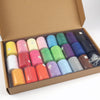 A box filled with 42 colorful polyester thread spools in various shades and colors for sewing and quilting.