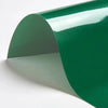 A sheet of dark green heat transfer vinyl rolled into a curved shape.