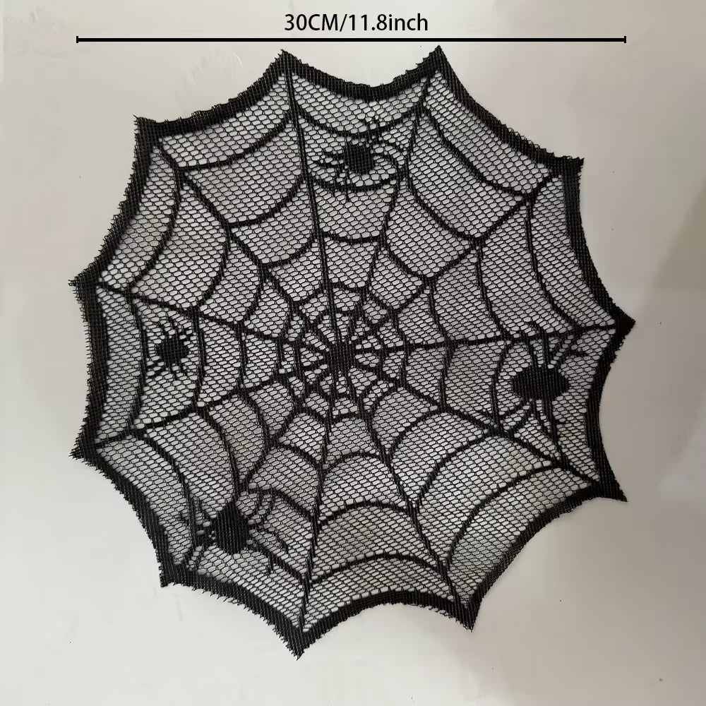A black lace spider web design on a clear mesh, used as a disposable table runner or placemat.
