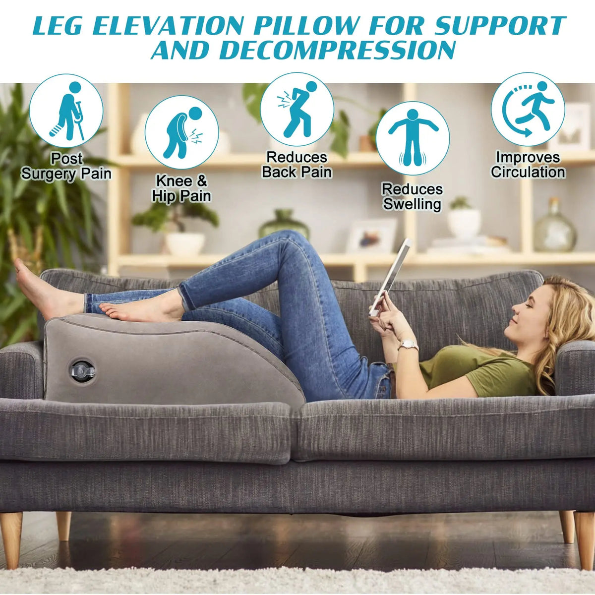 A woman is lying on a couch using a gray inflatable leg elevation pillow for support and decompression.