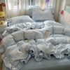 A light blue floral bedding set with a patterned duvet and pillows is displayed on a bed.