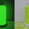 A roll of glow in the dark embroidery thread in lime green displayed on a white background.