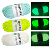 Three spools of glow-in-the-dark yarn in light blue, neon yellow, and white for knitting and crochet