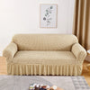 A beige stretch knit sofa cover featuring a bubble lattice texture displayed on a light-colored floor.