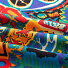 Close-up of colorful bohemian printed linen fabric showing various patterns and folds.