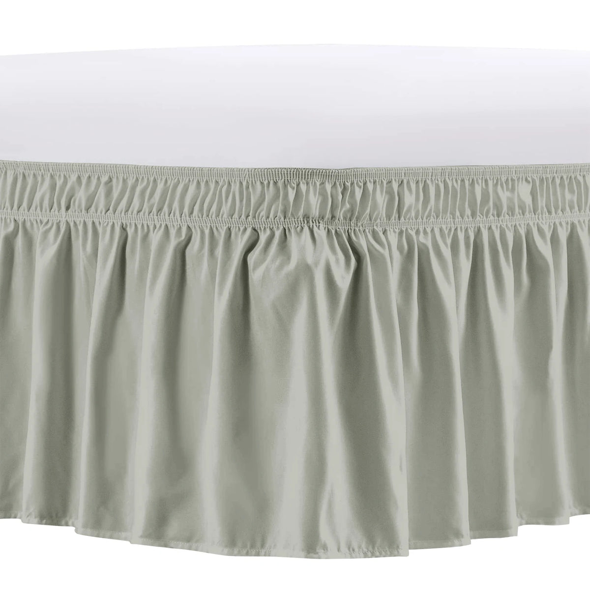 A light gray elastic bed skirt with ruffled trim