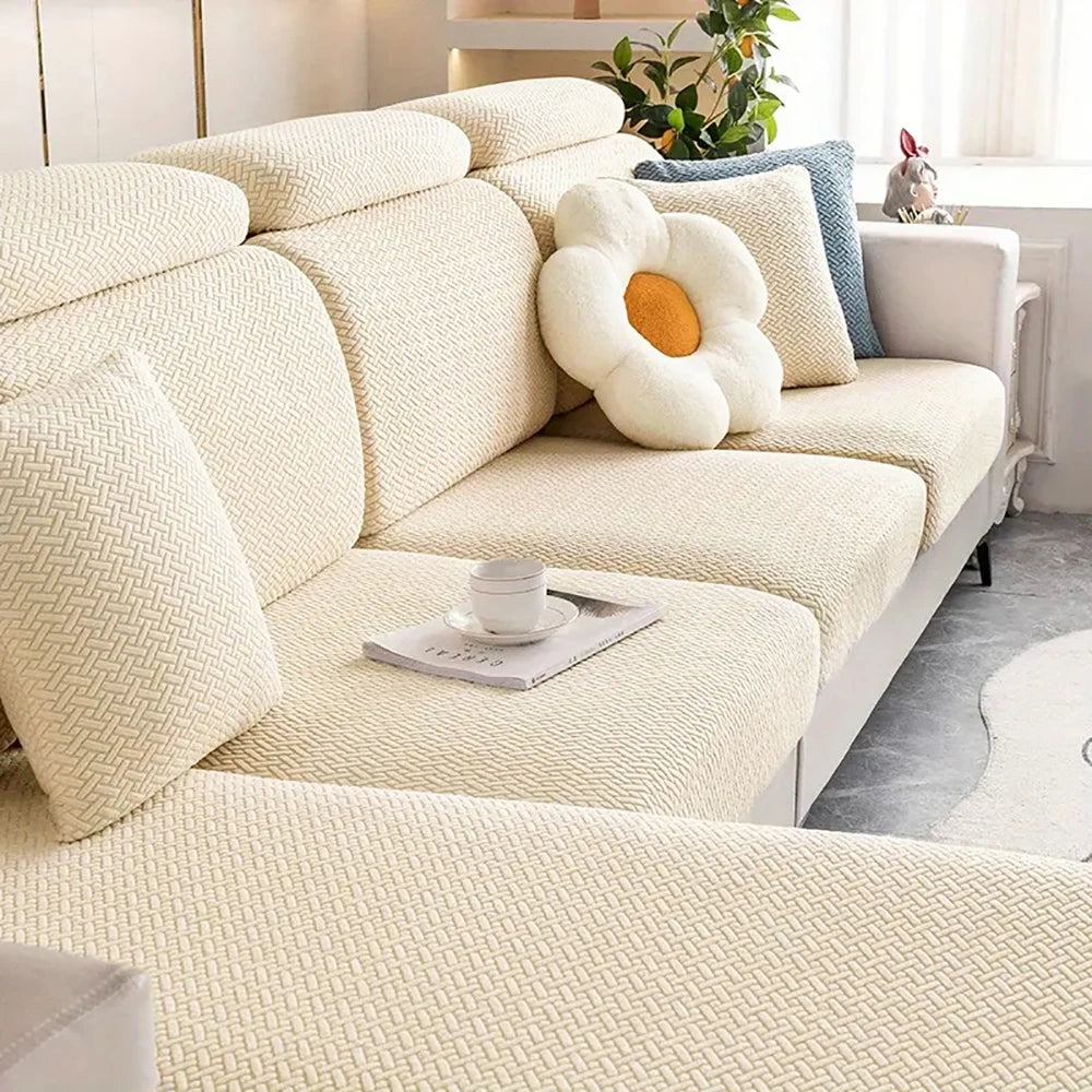 A cream-colored thick jacquard sofa seat cushion cover with a textured pattern and a decorative white flower cushion.