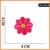 A single pink embroidered flower patch with a yellow center, part of a set of iron-on patches.