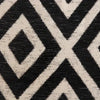 Close-up of a black and cream chenille jacquard fabric with an intersecting diamond pattern.