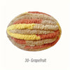 A round, hand-knitted yarn in horizontal stripes of peach, yellow, and pink tones.