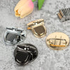 A collection of gold and silver metal twist locks for bags, cases, and DIY projects displayed on a gray surface.