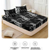 Black and white marble print fitted sheet set with pillowcases displayed on a bed.