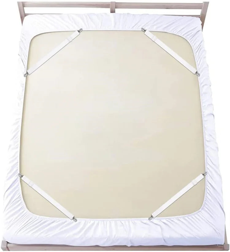 A white adjustable bed sheet with corner straps is shown on a wooden bed frame.