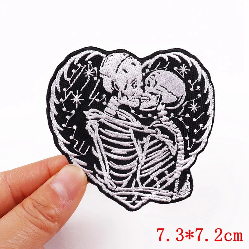 Black embroidery patch featuring a detailed rose skull design on a white background.