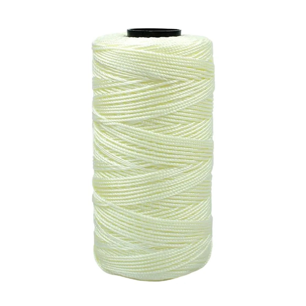 Spool of light green cotton silk thread for knitting and crafting