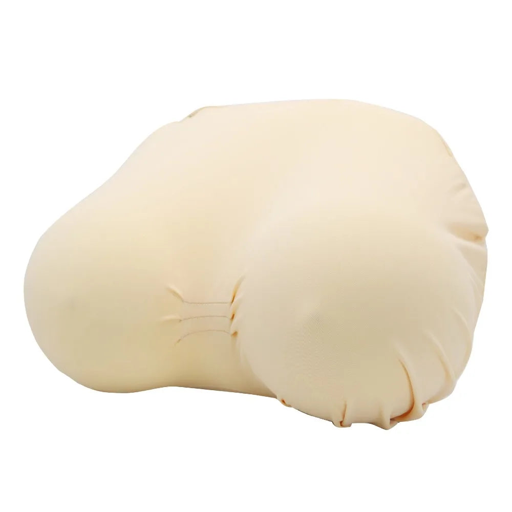 A beige memory foam contour chest pillow shown from the side.