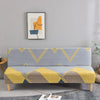 A light gray sofa with yellow and blue geometric print spandex slipcovers sits in a modern living room.