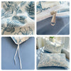 Close-up view of floral printed bedding set featuring blue and white botanical patterns on fabric and pillows.
