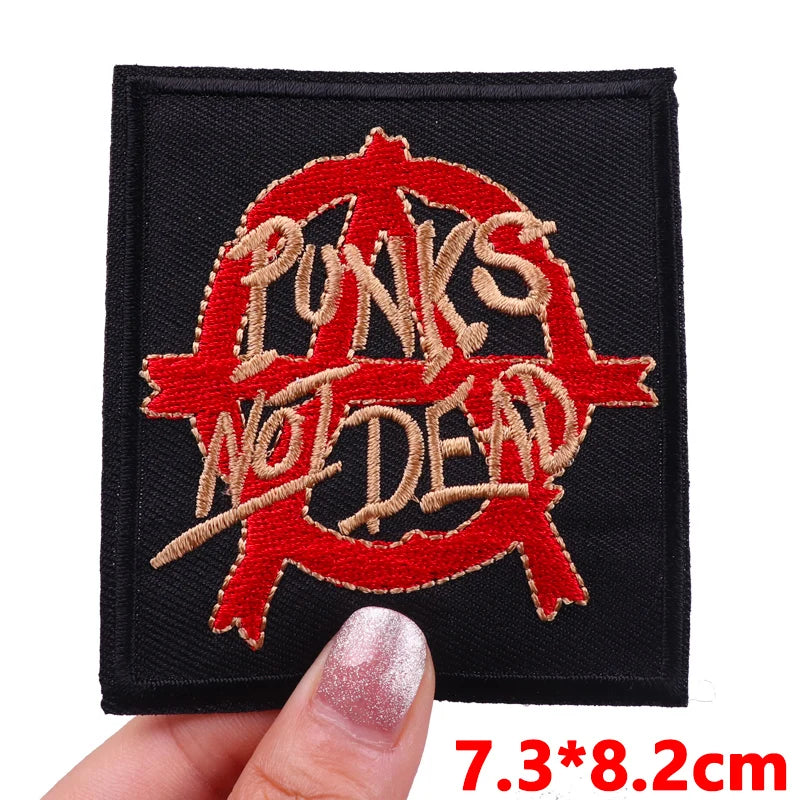 Black embroidered patch featuring the text PUNKS WOLDDEAD in red thread