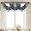 Gray European style window curtain valance with tasseled fringe hanging over a window.