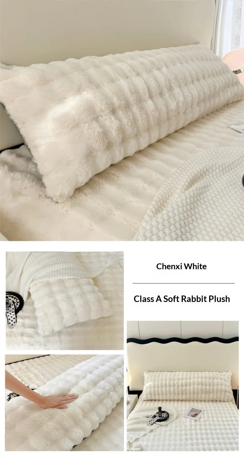 A white rabbit plush long pillowcase is shown on a bed, featuring quilted texture and soft fur.
