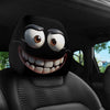 A black decorative smiley face car pillow cover is shown on a car seat.