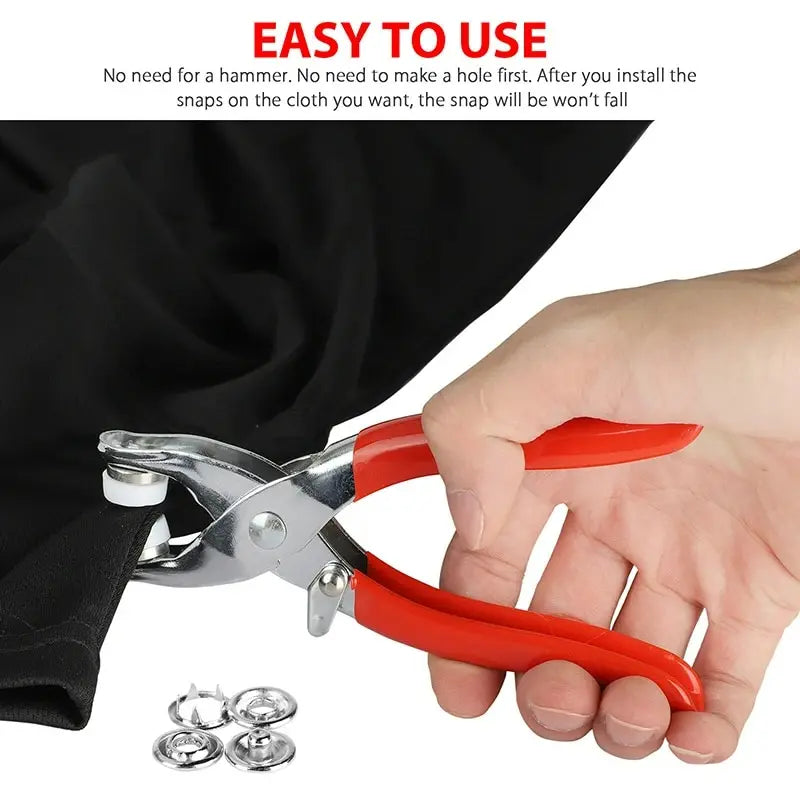 A hand is using metal prong rings and snap buttons to install a snap on fabric for DIY sewing.