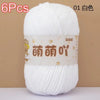 A ball of white soft bulky chenille yarn labeled 6pcs and 01 color for crochet and knitting.