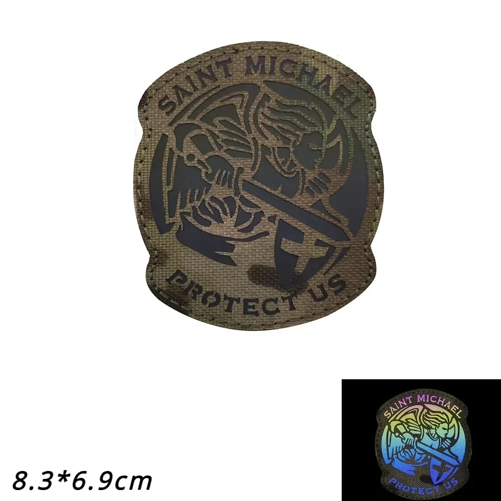 Dark brown embroidered patch featuring a silhouette of an angel and the text SAINT MICHAEL PROTECT US