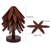 A natural wooden tree-shaped coaster set with twelve dark brown wooden leaves.