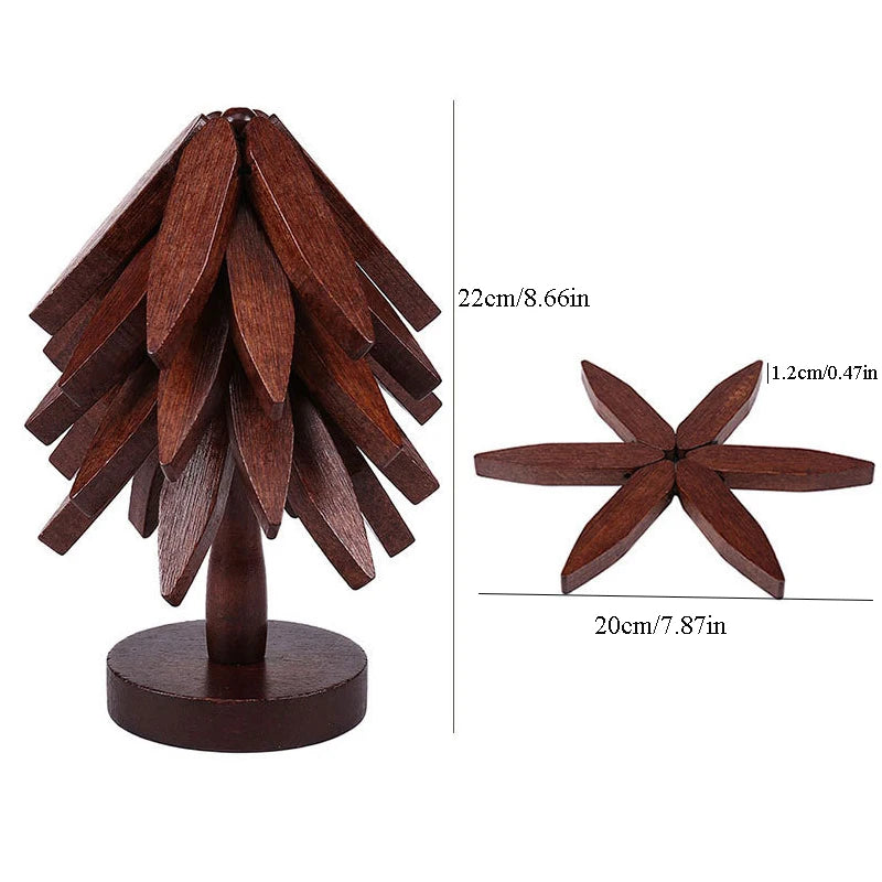 A natural wooden tree-shaped coaster set with twelve dark brown wooden leaves.