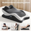 A multifunctional sleeping pillow in black and white rests on a bed, shown from multiple angles.