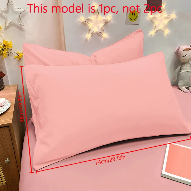Pink matte solid color pillowcases displayed on a bed with decorative star lights