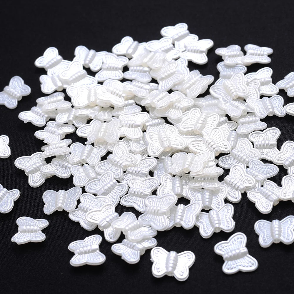 A pile of white imitation pearl flower spacer beads for DIY jewelry