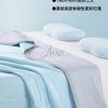 A light blue and gray ice silk blanket is shown folded on a white surface with soft pillows nearby.
