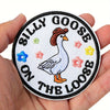 Embroidered hook and loop patch featuring a white goose on the loose design surrounded by floral elements.