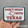 A rectangular embroidered patch with the text DON'T MESS WITH TEXAS in red thread on a white background.