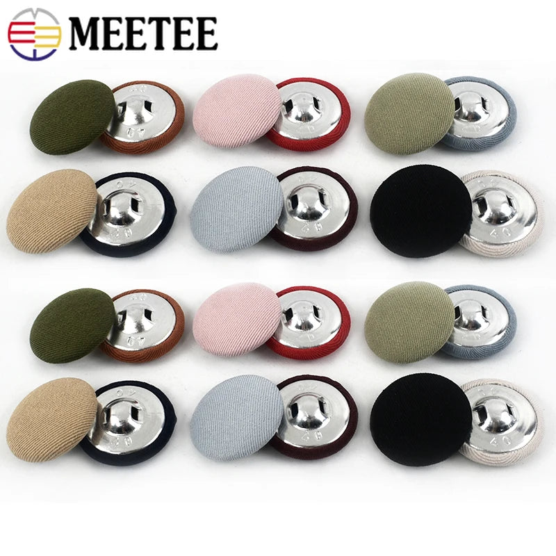A set of round fabric-covered shank buttons in various colors including olive green, pink, gray, and black.