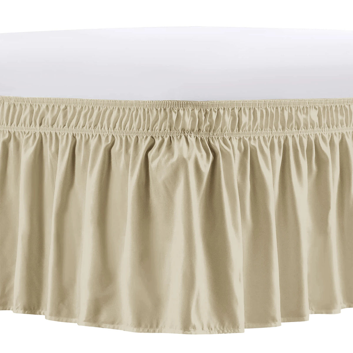 A beige elastic bed skirt with ruffled trim and gathered fabric.