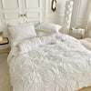 White bohemian solid color duvet cover set displayed on a bed with white linens and wooden accents.