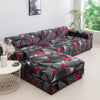 A black and red geometric patterned sofa protector cover lying on a light floor.