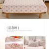 Pink floral printed cotton fitted sheet displayed on a bed with matching pillows and bedding.